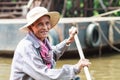 An unidentified man smiles Kompong Phluk paddling a boat