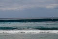 Unidentified man on surf board waiting for wave in blue water back view. Young Boys Waits the Waves. Surfer waiting in line for a Royalty Free Stock Photo