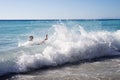 Unidentified man swimming in large waves