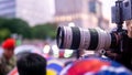 Unidentified man taking a picture using Sony camera with Canon lens on a tripod