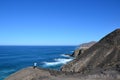 Unidentified man taking pictures on the steep cliff , Fuerteventura, Canary Islands, Spain.