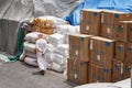 An unidentified man wearing traditional Arab outfit walks through port warehouse.