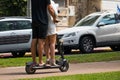 Unidentified Man and women riding an electric scooter