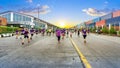 Unidentified marathon athletes running on city road.