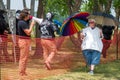 Unidentified Masked Protestors and Woman Holding Umbrella at Hudson Pride