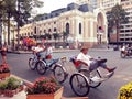 Unidentified men with tricycles in Saigon (Hochiminh city) under vintage color