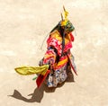 Monk in a bull deity mask performs a religious masked and costumed mystery dance of Tantric Tibetan Buddhism on the Cham Dance