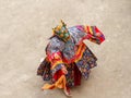 Monk in a bull deity mask with ritual dagger phurpa performs a religious masked and costumed Cham dance of Tibetan Buddhism