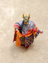 Monk in a bull deity mask with ritual dagger phurpa performs a religious masked and costumed Cham dance of Tibetan Buddhism Royalty Free Stock Photo