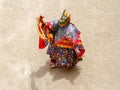 Monk in a bull deity mask with ritual dagger phurpa performs a religious masked and costumed Cham dance of Tibetan Buddhism
