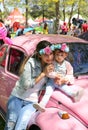 Unidentified mother and daughter taken picture with old Volkswagen Beetle Royalty Free Stock Photo