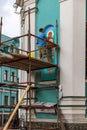 An unidentified Muralist repair a painting on the wall of an Orthodox church.