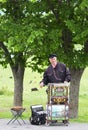 Unidentified musician plays on barrel organ at the market