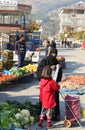 Unidentified Muslim Syrian Woman with daughter buying fruit and vegetables at Local Farmers Market in Ovakent, Hatay, Turkey