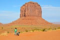 Unidentified navajo children playing in the sand of monument valley