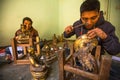 Unidentified Nepalese tinman working in the his workshop