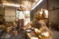 Unidentified Nepalese tinman working in the his workshop.