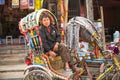 Unidentified nepali rickshaw in historic center of city, Nov 28, 2013 in Kathmandu, Nepal.