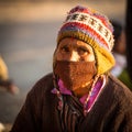 Unidentified old local Nepalese woman on the Old Durbar Square with pagodas. Royalty Free Stock Photo