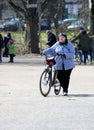 Unidentified Old Woman with a Bicycle by The Maschsee Lake in Hannover, Germany