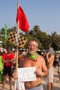 An unidentified older man with sign in his hands at the annual festival of Freaks, Arambol beach, Goa, India, February 5, 2013.