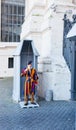 Unidentified Papal Swiss guard standing at the Vatican Museums door in the Vatican.