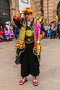 Unidentified participant in traditional clothes celebratesreligious festivity in front of the Cathedral of Santo Domingo in Cusco