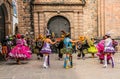 Unidentified participants in traditional clothes celebrate religious festivity in front of the Cathedral of Santo Domingo in Cusco