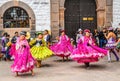 Unidentified participants in traditional clothes celebrate religious festivity in front of the Cathedral of Santo Domingo in Cusco