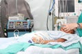 Unidentified patient receiving oxygen by a breathing mask holded by a nurse