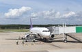 Unidentified people and airplane connected to the jetway