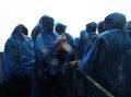 Unidentified people in blue rain coats enjoying Royalty Free Stock Photo