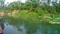 Unidentified people canoeing safari on wooden boats Pirogues on the Rapti river, in Chitwan National Park Royalty Free Stock Photo