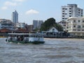 Unidentified people cross Chao Phraya river by ferry boat in Bangkok, Thailand. Royalty Free Stock Photo