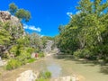 Unidentified people enjoy swimming, relaxing at Honey Creek where it tumbled over Bridal Veil Falls upstream from Turner Falls, Royalty Free Stock Photo