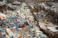 Unidentified people from poorer areas working in sorting of plastic on the dump. Royalty Free Stock Photo