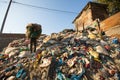 Unidentified people from poorer areas working in sorting of plastic on the dump. Royalty Free Stock Photo