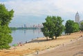 Unidentified people are resting on the beach of Dnipr river in Obolon district