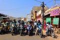 Unidentified people ride motorbikes by the street during evening rush hour