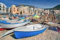 Unidentified people on sandy beach in Cefalu, Sicily, Italy