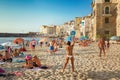 Unidentified people on sandy beach in Cefalu, Sicily, Italy Royalty Free Stock Photo