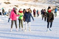 Unidentified people skating on the outdoor ice rink