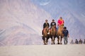 Unidentified people travellers riding on camels Royalty Free Stock Photo
