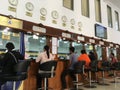 Unidentified people wait at service counters at ACLEDA Bank