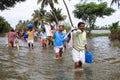 People walk through the flooded roads