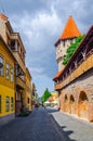 Unidentified people wander along the medieval defense wall and The Carpenters' Tower in Sibiu city, Transylvania Royalty Free Stock Photo