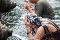 Unidentified persons pray and bath