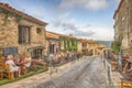 Unidentified poople eating in street restaurant, Architecture of Ramatuelle city in French Riviera, France