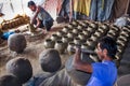 Unidentified potter making clay water pots on pottery wheel.