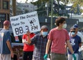 Unidentified protestor preparing for a cars and bicycle caravan promoting prop 15